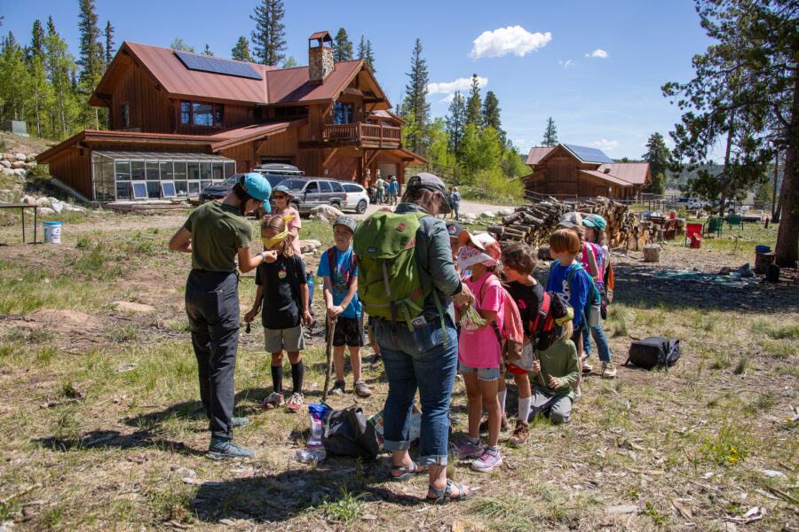 Group of volunteers and children during Wild Week at the Sacramento Creek Ranch.
